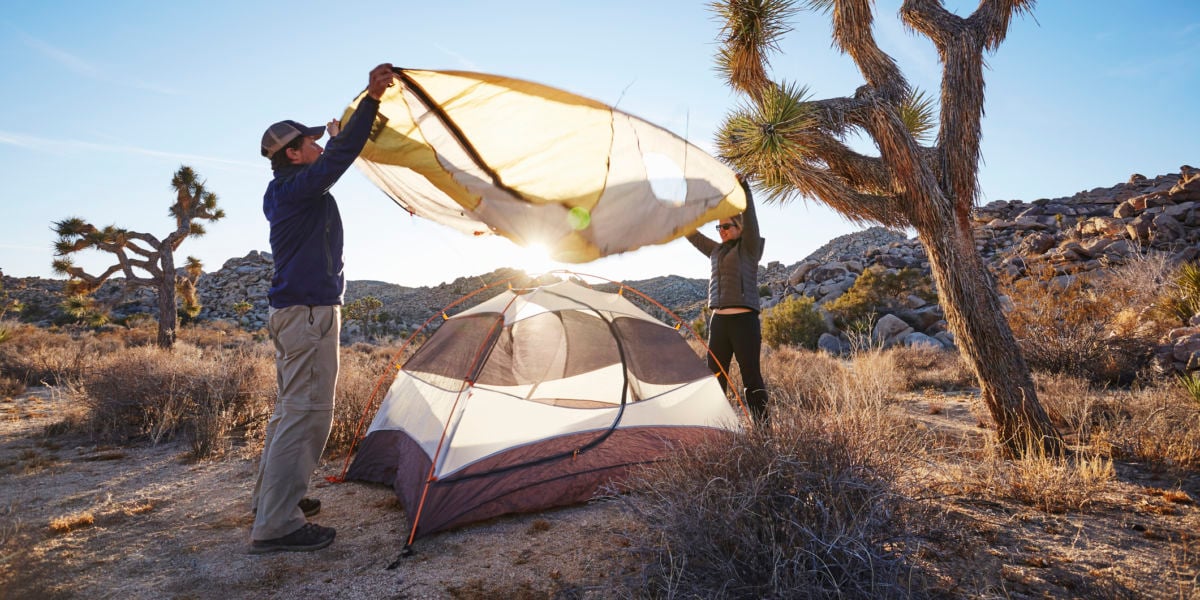 people setting up a camping tent